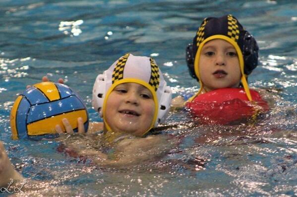 An image of two children playing water polo.